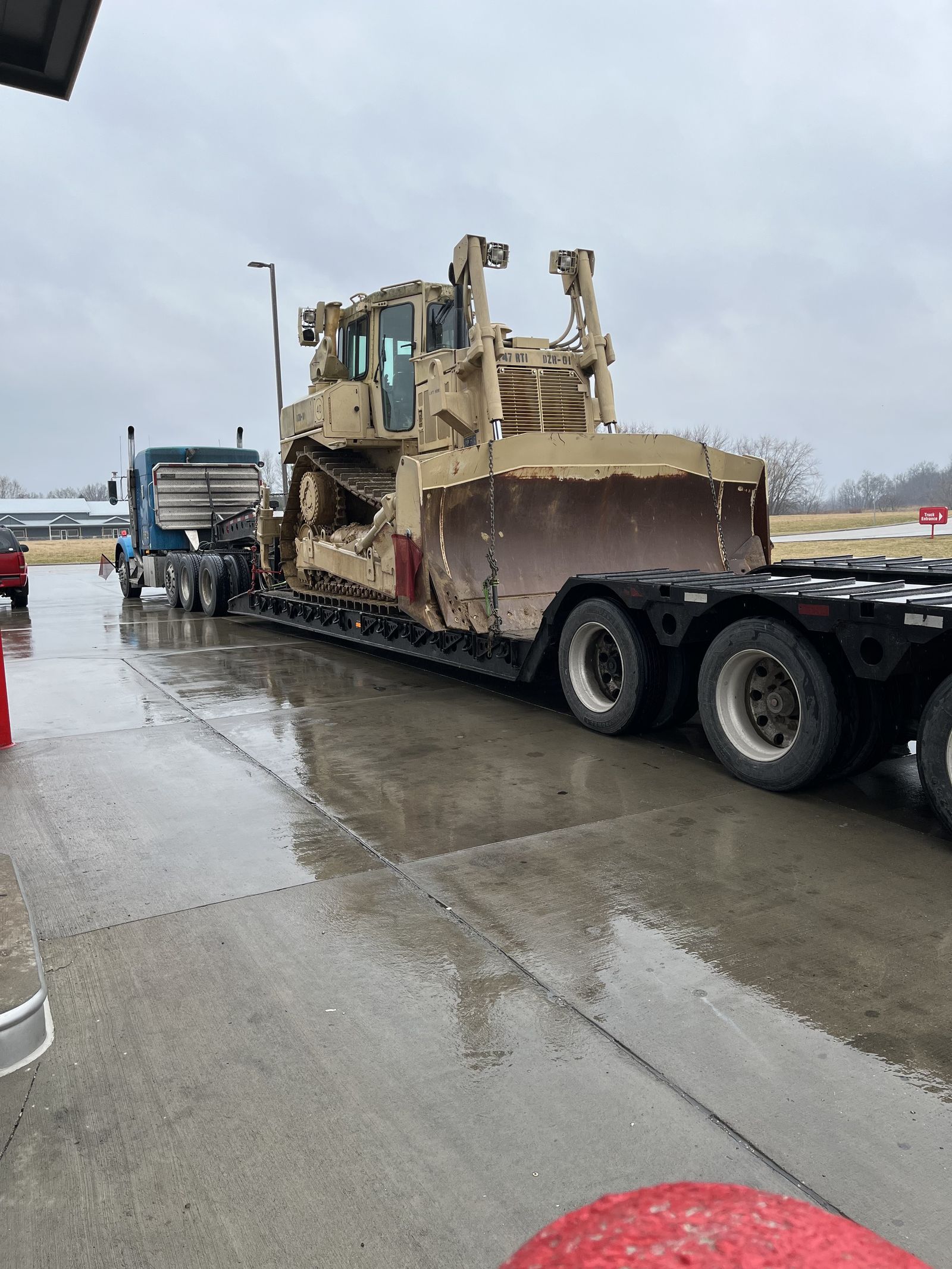 Bulldozer on lowboy in rain
