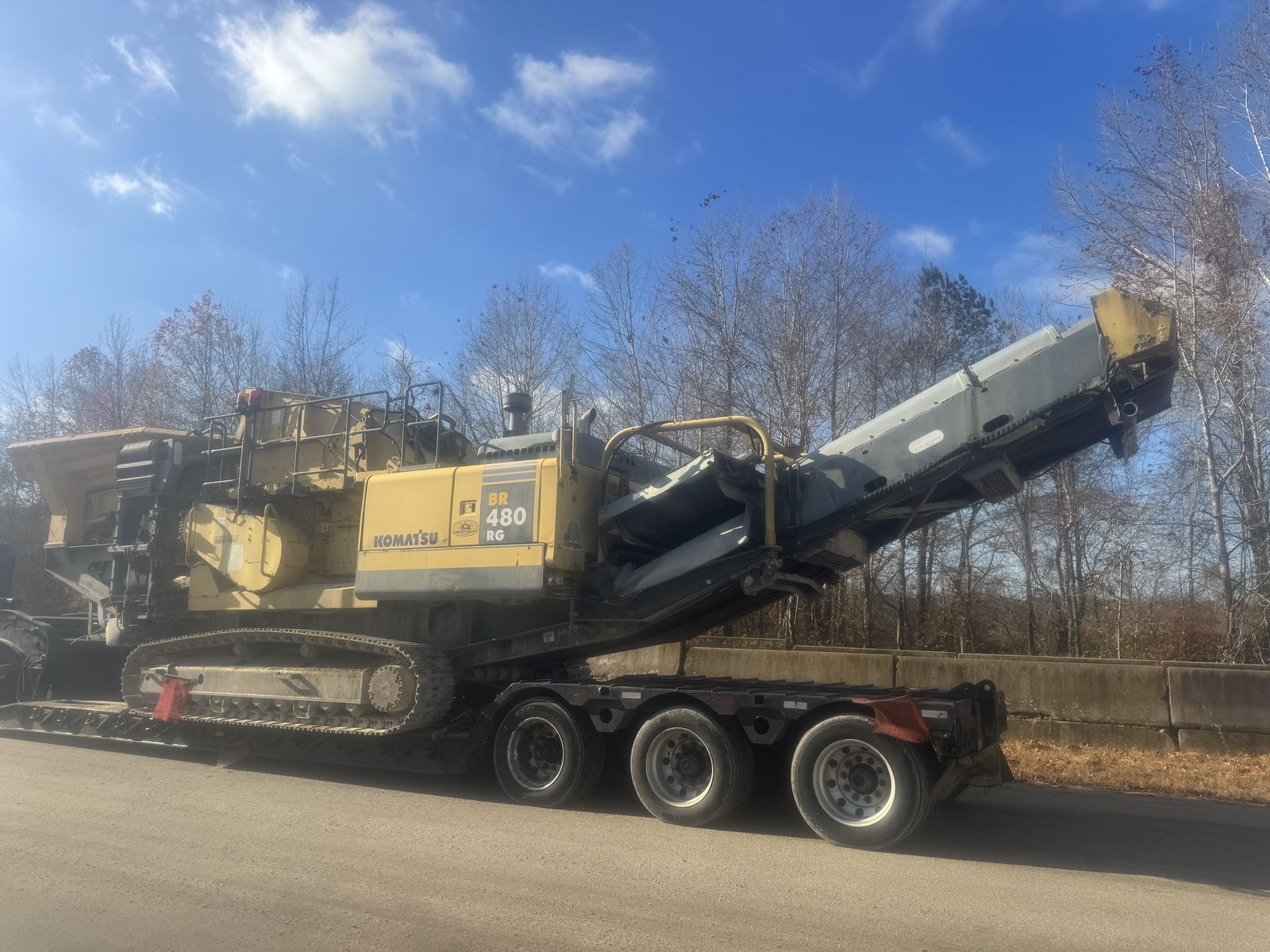 Komatsu crusher on lowboy trailer