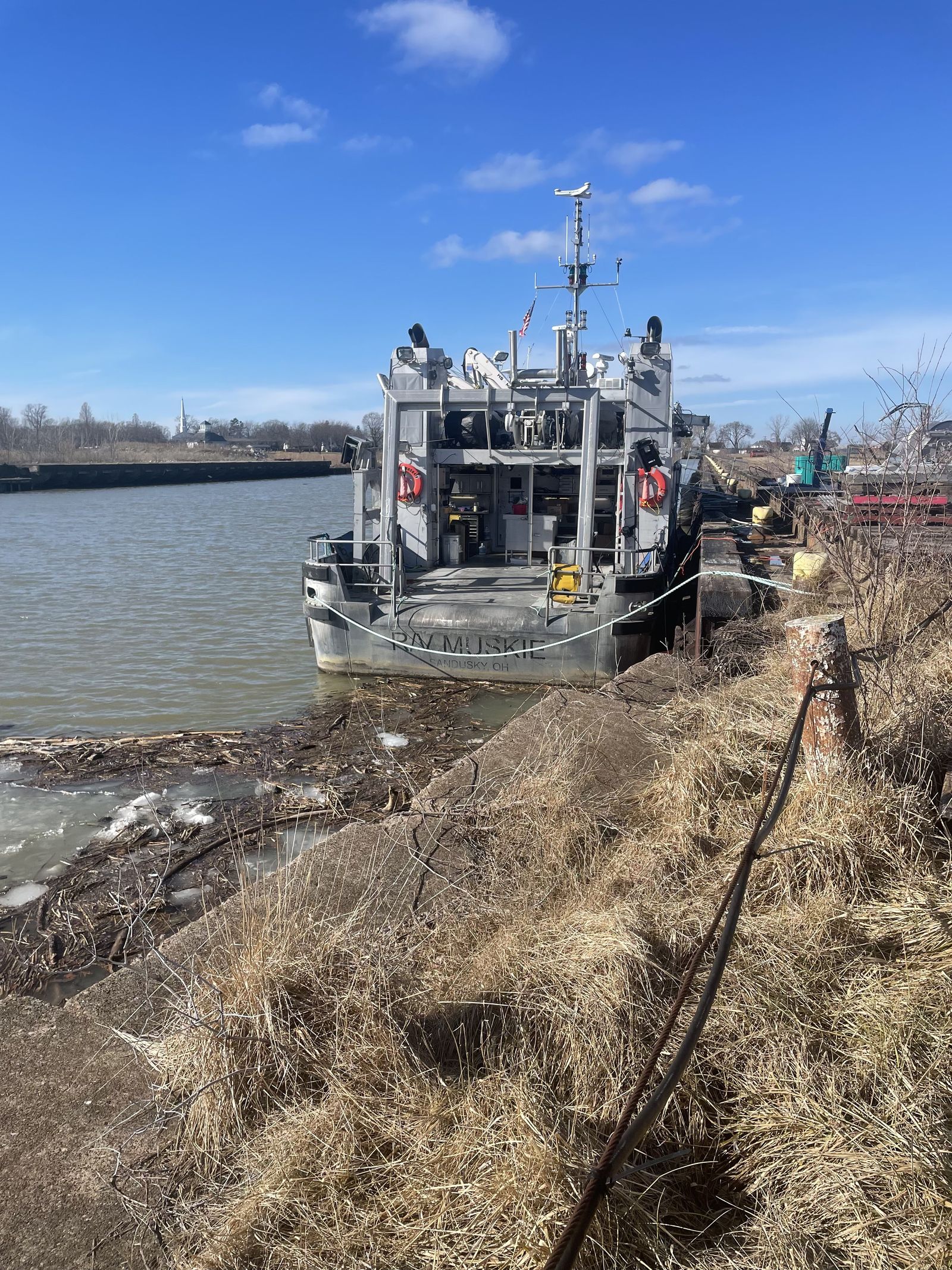 Military tugboat docked at river